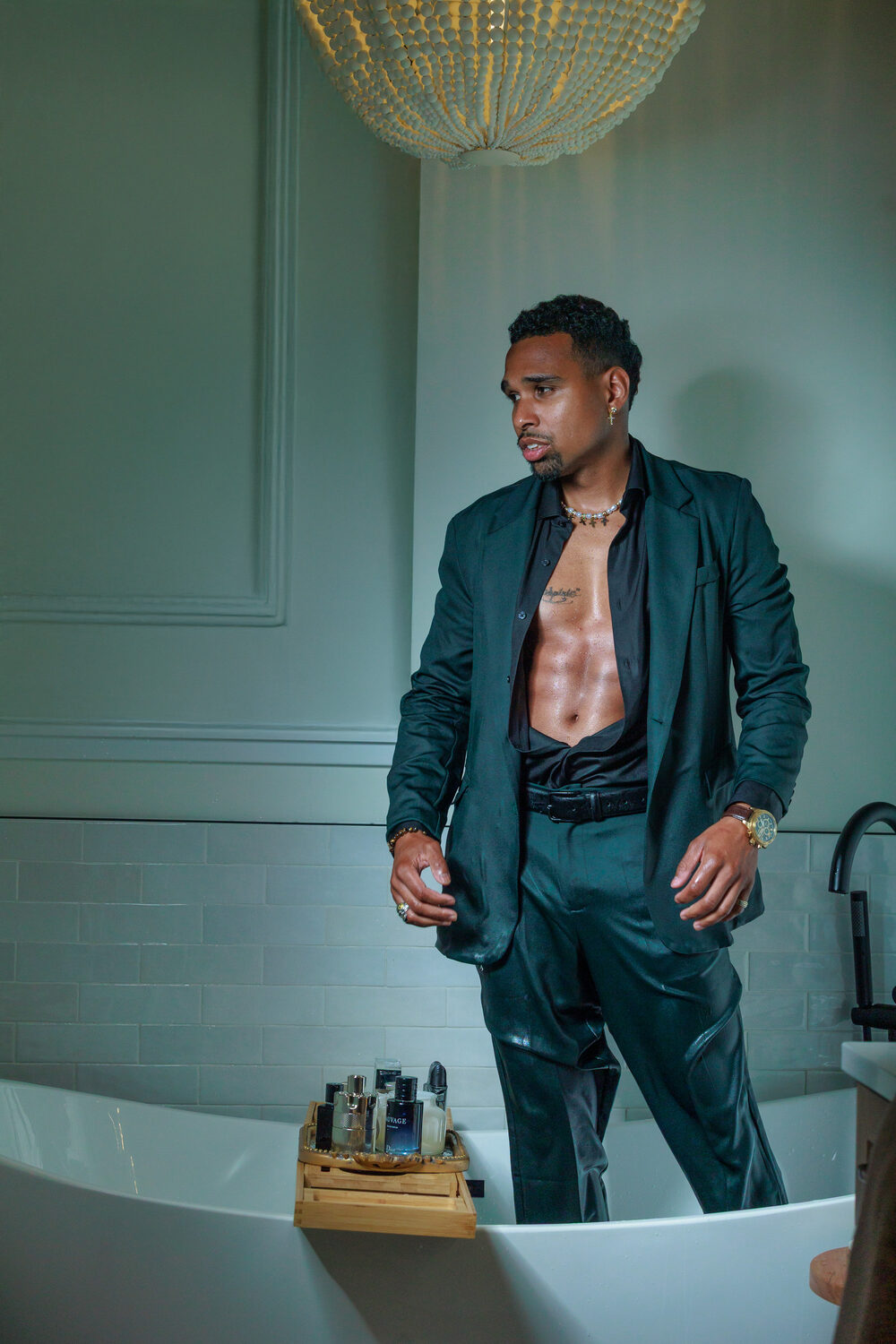 Editorial portrait, green satin suit with chandelier