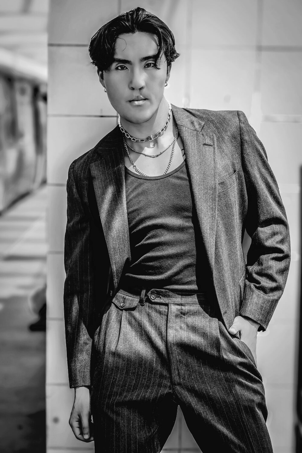 B&W editorial portrait, pinstripe suit