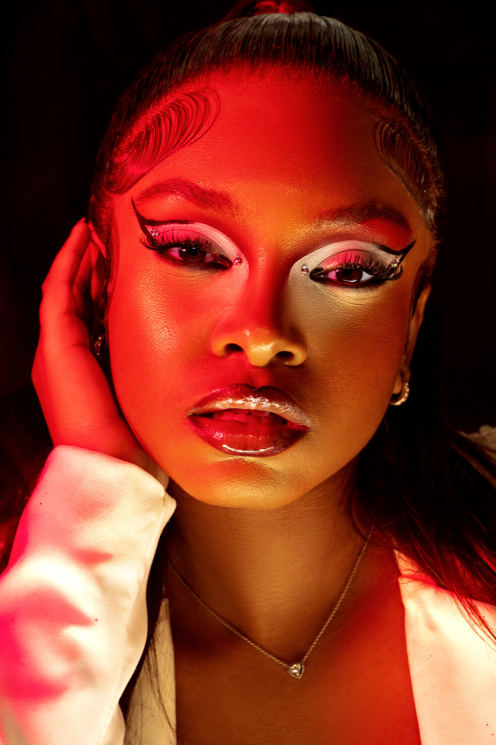 Editorial beauty portrait, red dramatic lighting